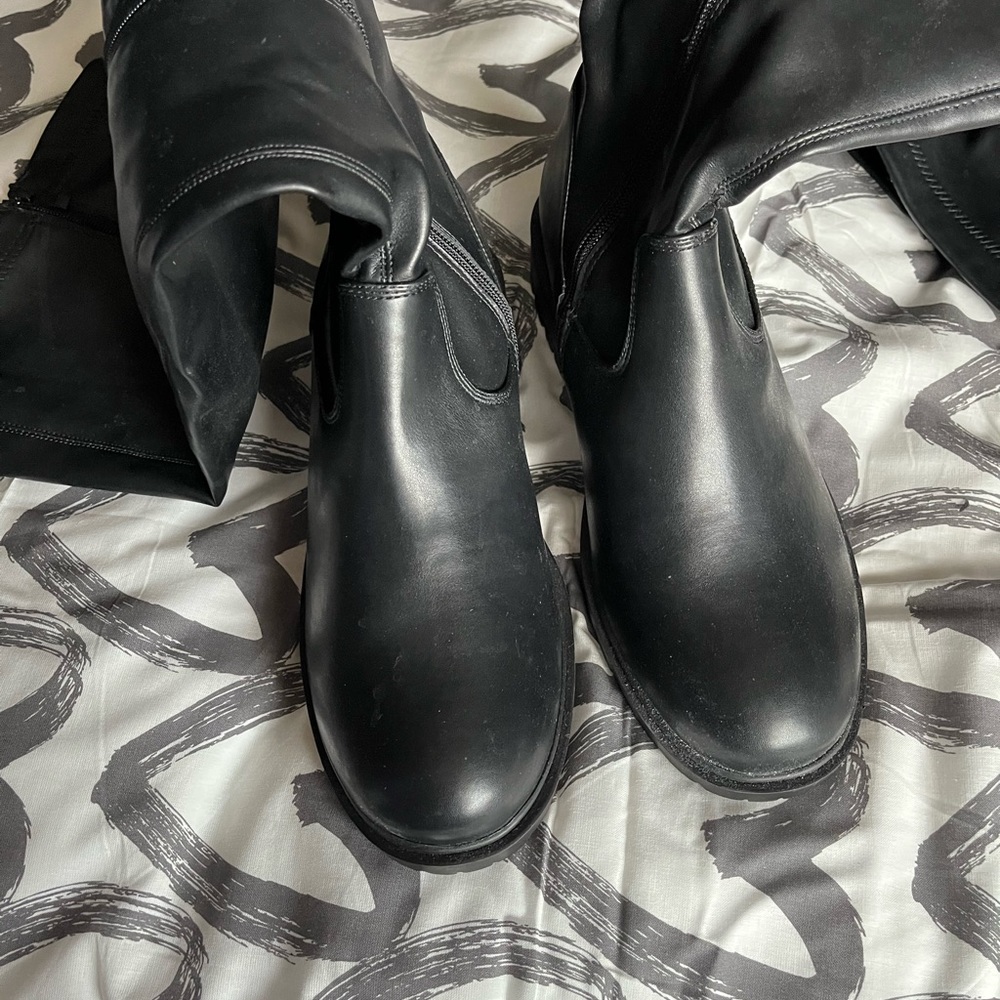 Tall black faux leather above the knee. Some stretch
